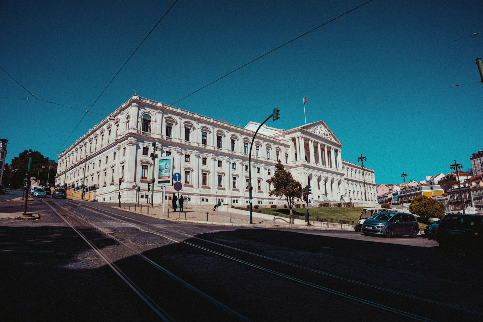a large white building sitting on the side of a road